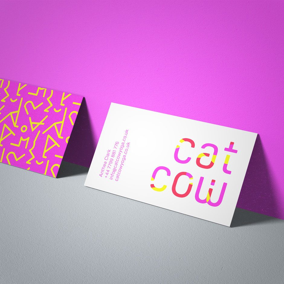 catcow yoga branding applied to business card against pink wall